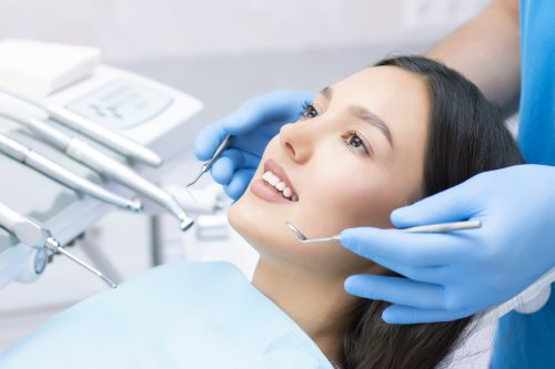 young-female-patient-with-pretty-smile-examining-dental-inspection-dentist-clinic-1-scaled.jpg